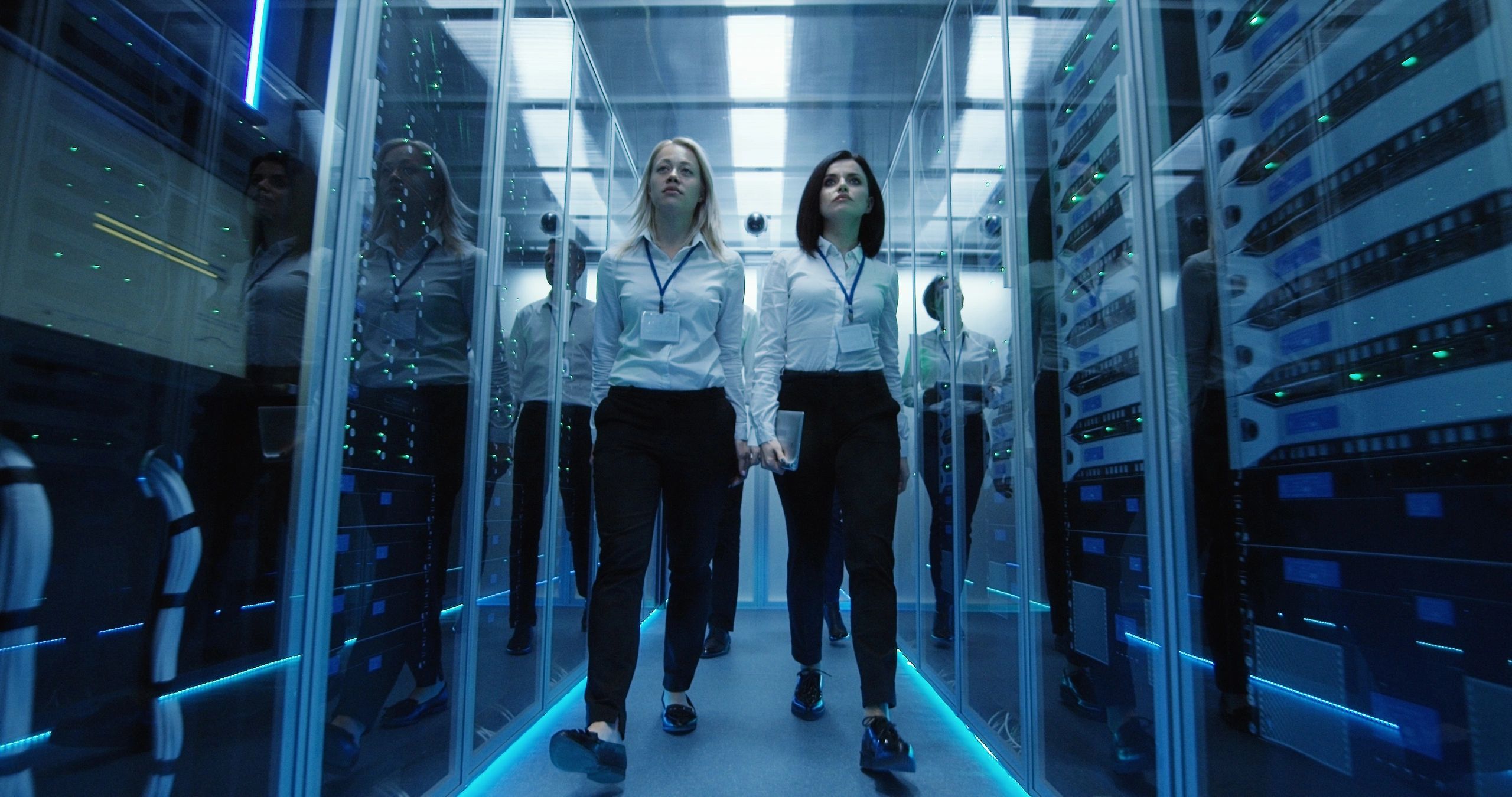 Workers walking through a secure data center