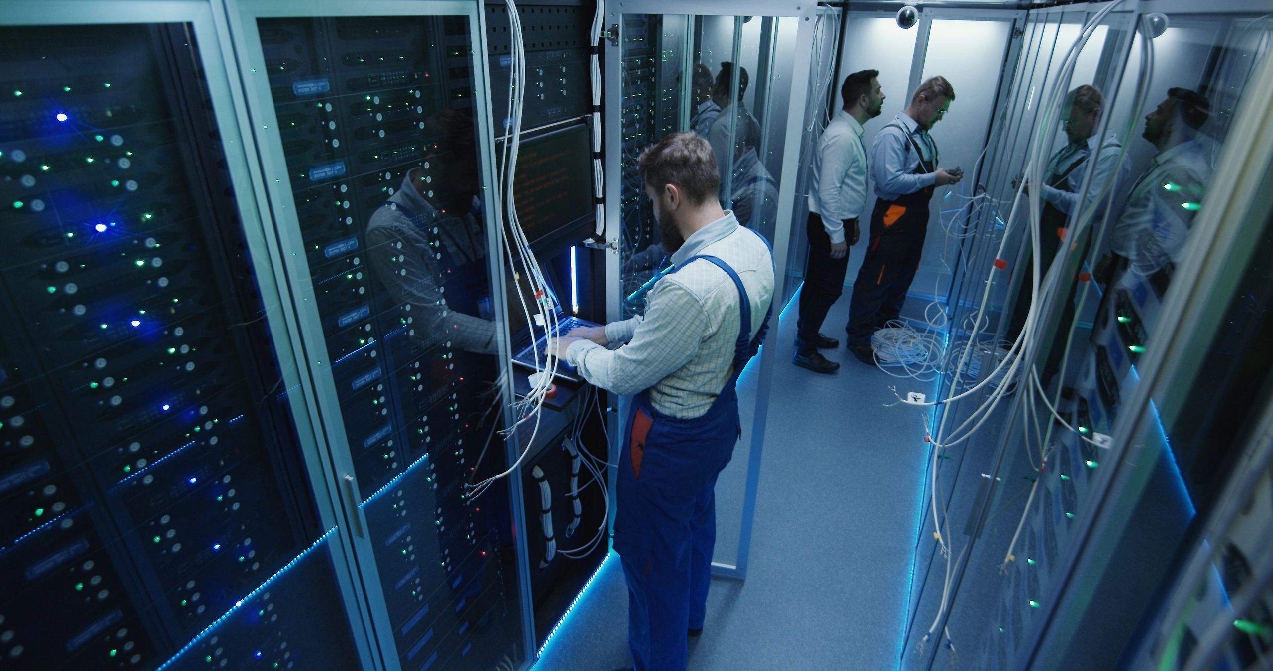 Technicians working in a data center server room