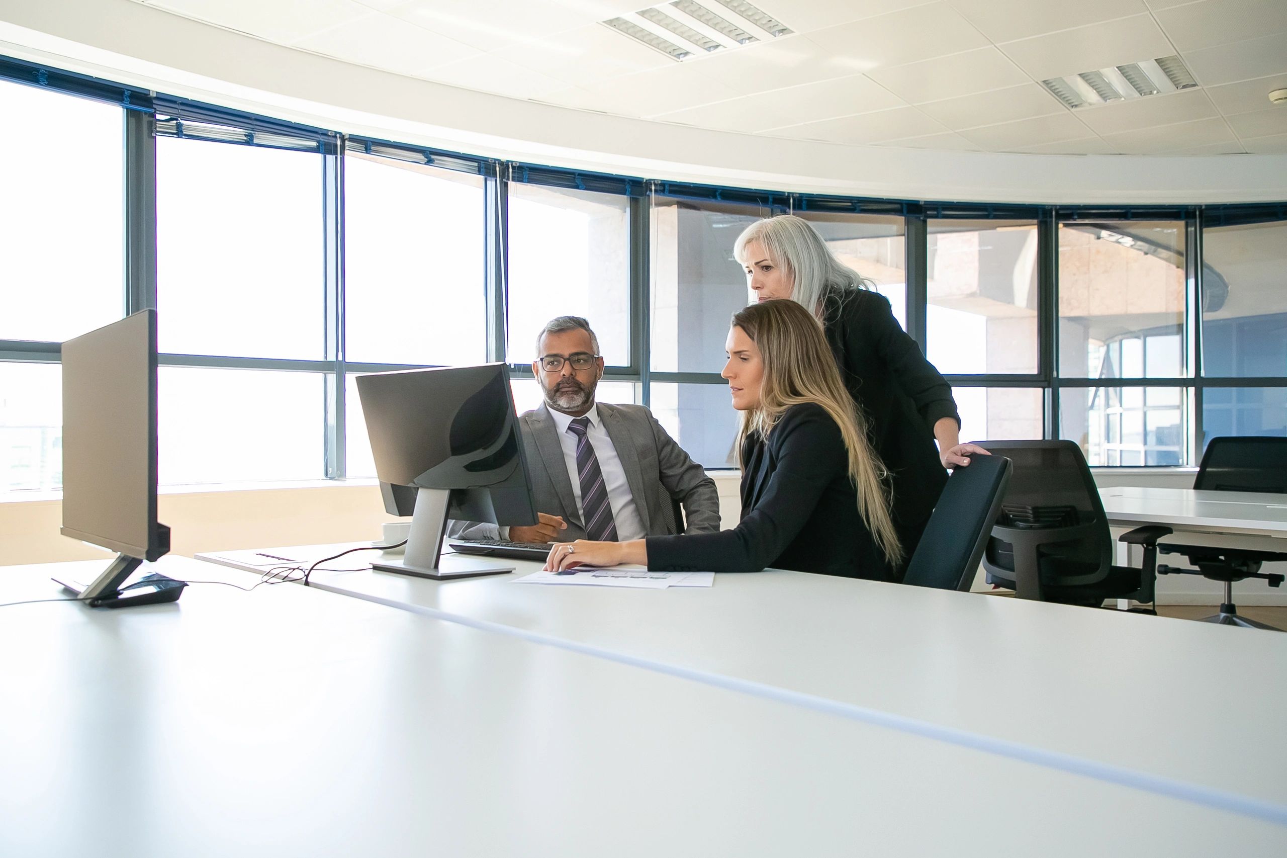 Business leaders reviewing technology solutions together
