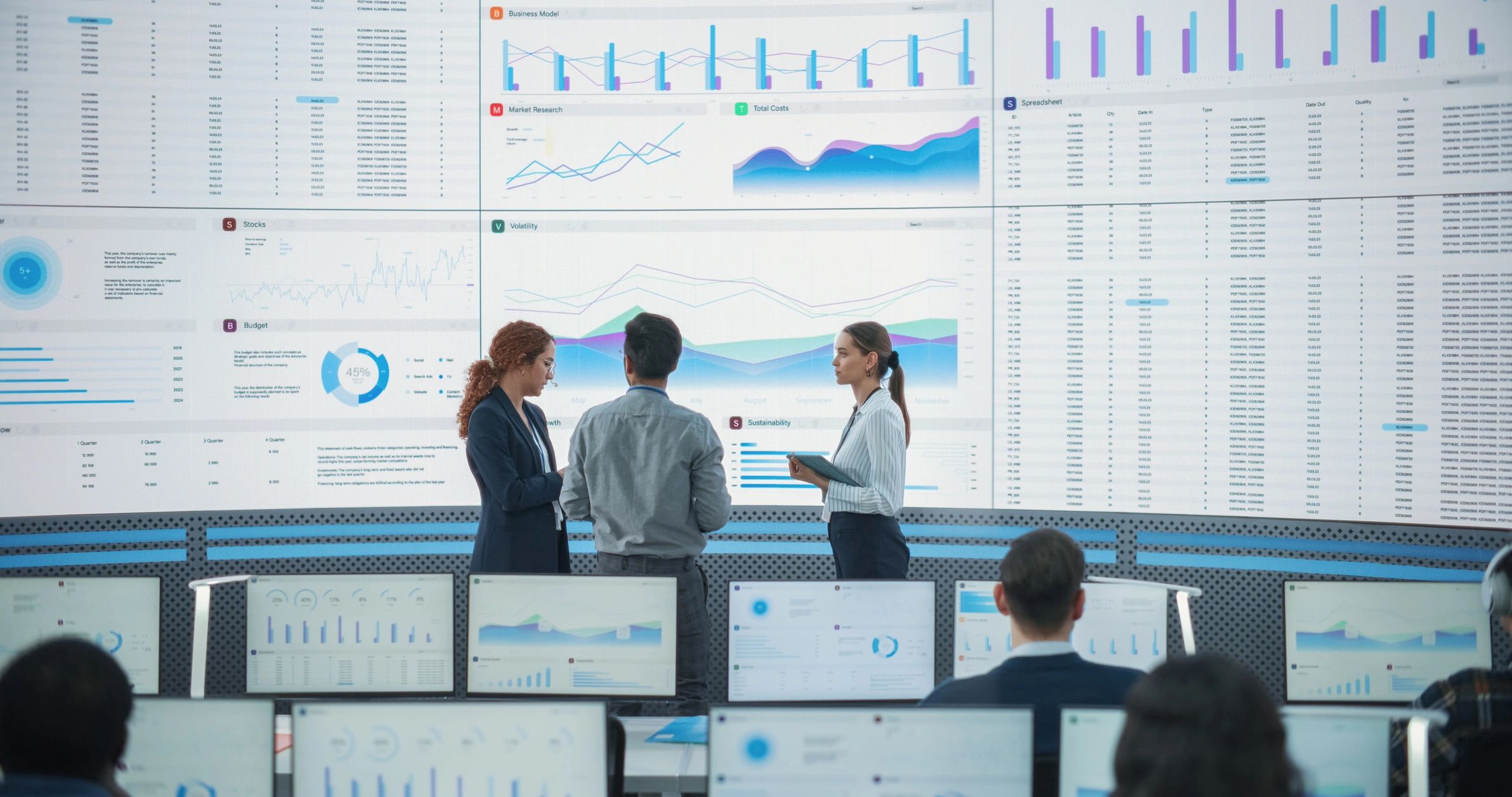 Network operations center team monitoring dashboards on large screens