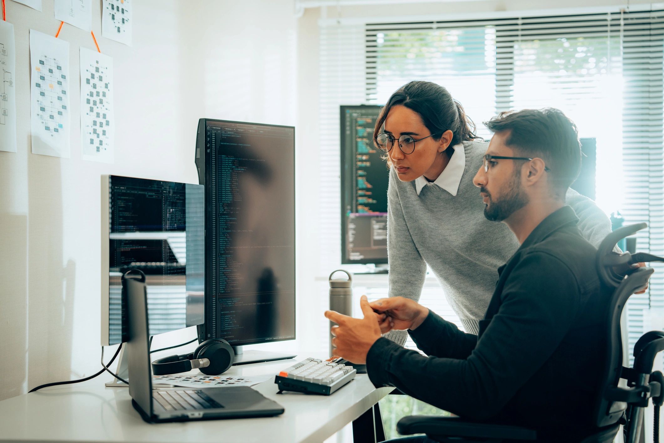 Two IT professionals collaborating in a network operations setting